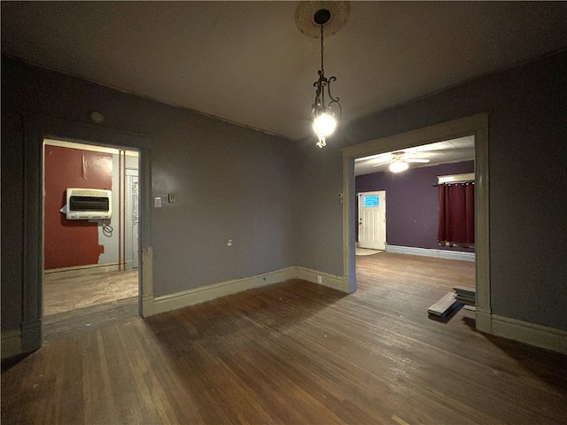 unfurnished dining area with hardwood / wood-style floors, heating unit, and ceiling fan