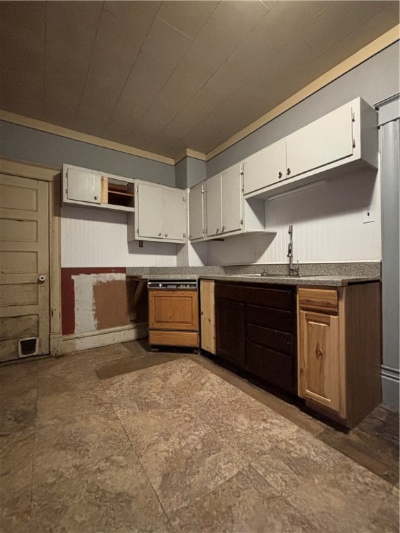 kitchen featuring white cabinetry and sink