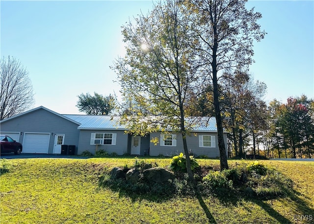 ranch-style home with a front lawn and a garage