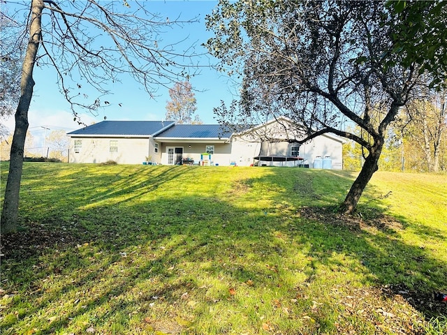 rear view of house featuring a lawn