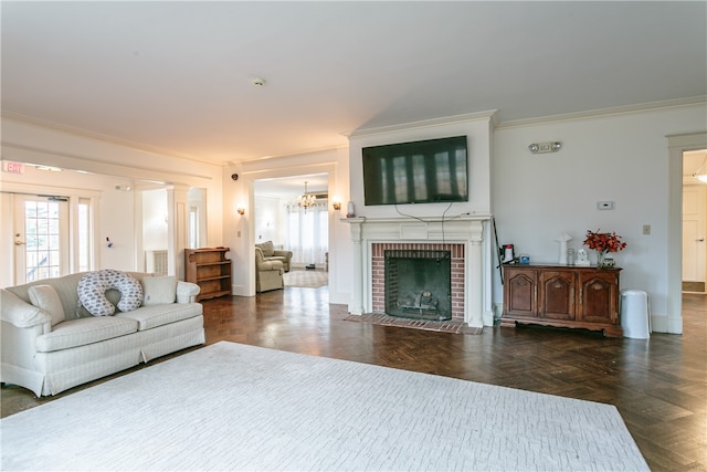 living room featuring ornate columns, crown molding, a fireplace, and dark parquet floors