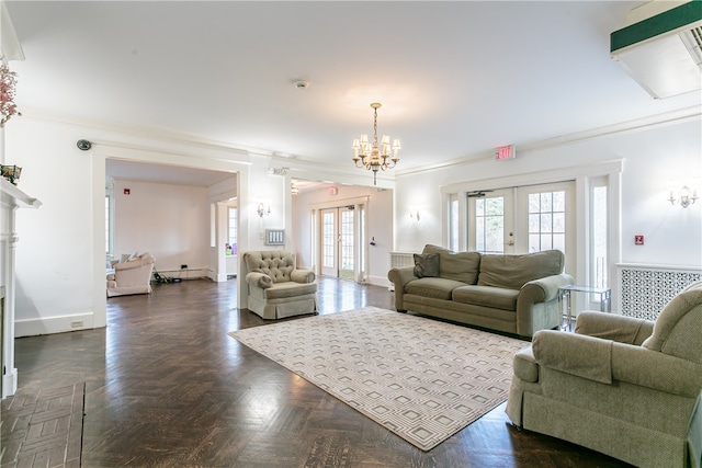 living room with dark parquet flooring, french doors, ornamental molding, and a notable chandelier