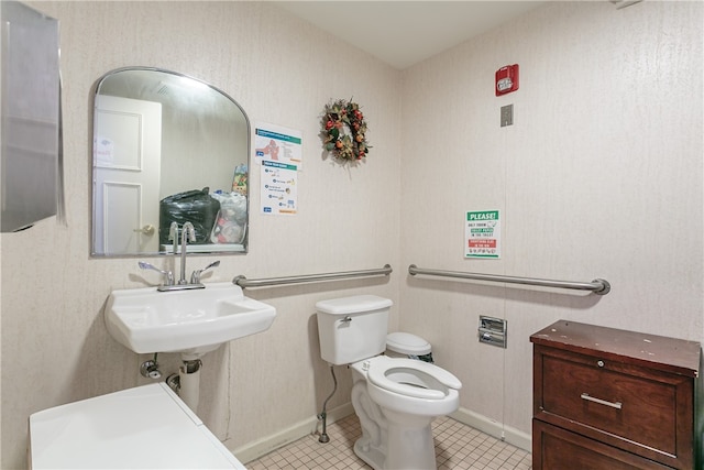 bathroom featuring tile patterned flooring, toilet, and sink