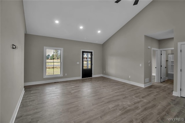 interior space featuring ceiling fan, high vaulted ceiling, and light hardwood / wood-style flooring