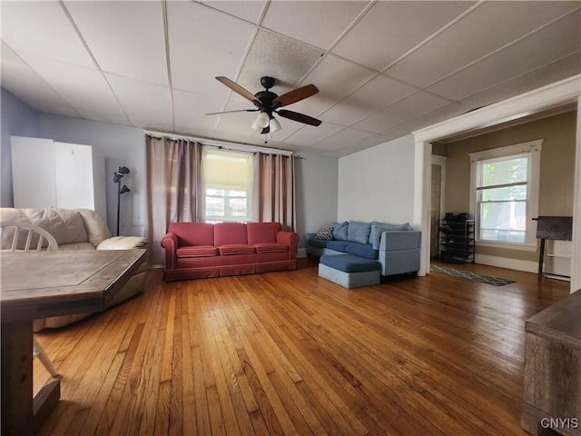 unfurnished living room featuring hardwood / wood-style floors, a paneled ceiling, and ceiling fan