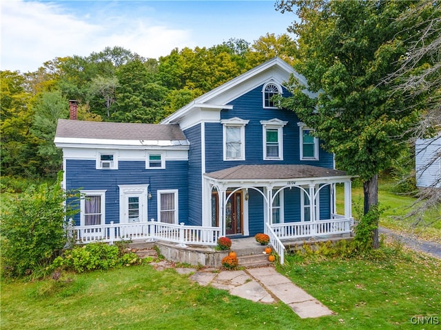 view of front of home featuring a front lawn and covered porch