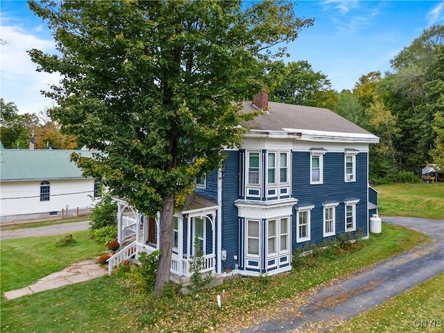 view of property exterior with a lawn