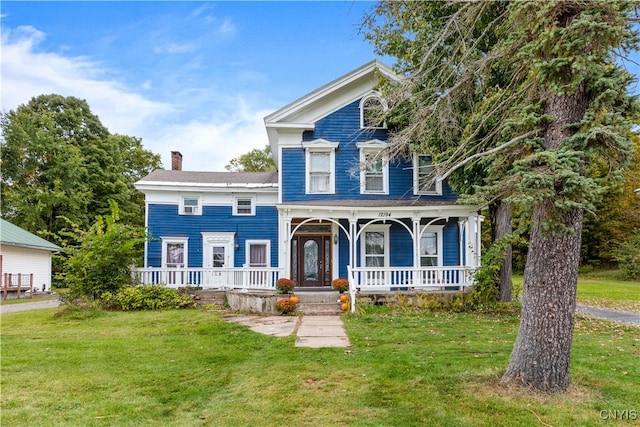 view of front of home featuring covered porch and a front yard