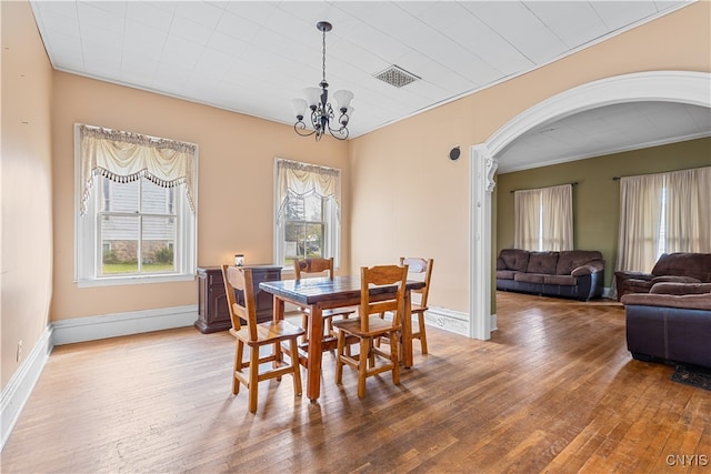 dining space with a notable chandelier and wood-type flooring