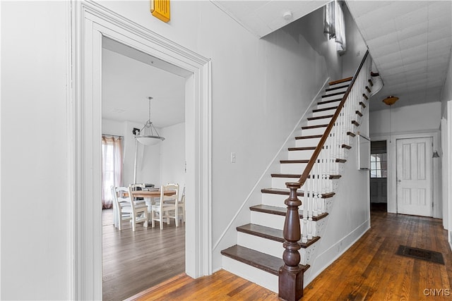 stairs with hardwood / wood-style floors