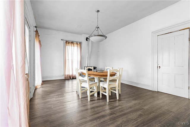 dining space with dark hardwood / wood-style floors