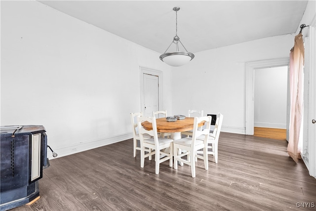 dining space with dark hardwood / wood-style flooring