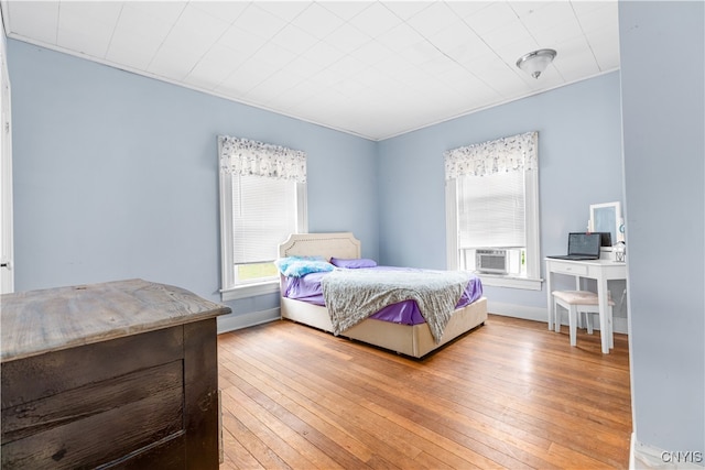 bedroom with hardwood / wood-style floors and cooling unit