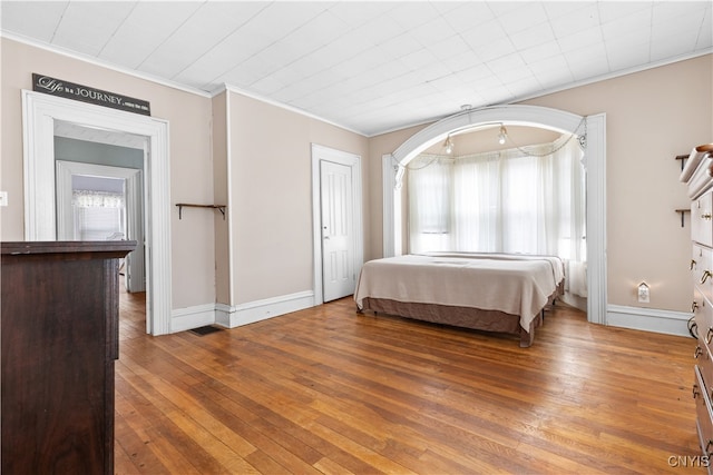 bedroom featuring crown molding and hardwood / wood-style floors