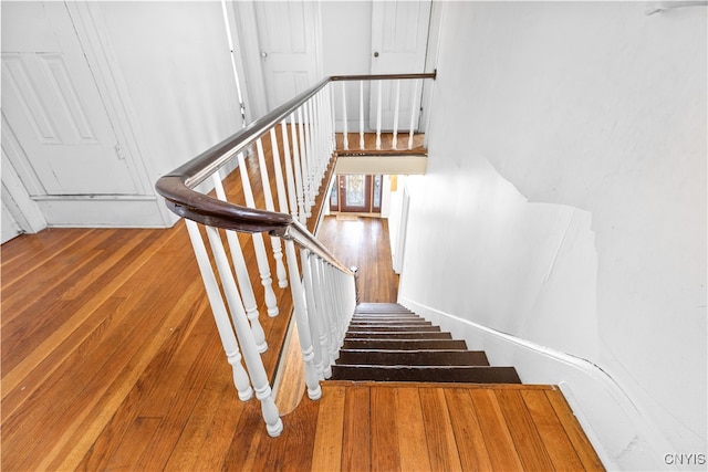 staircase featuring wood-type flooring