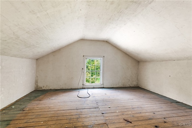 bonus room featuring wood-type flooring and vaulted ceiling