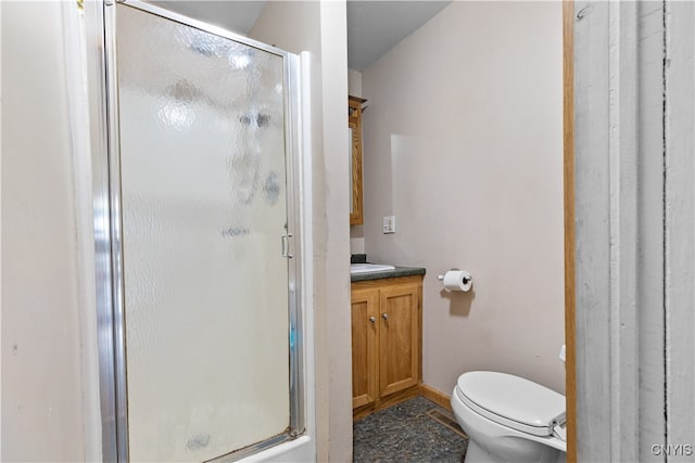 bathroom with vanity, toilet, and a shower with shower door