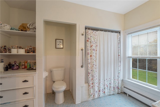 bathroom featuring shower / tub combo, tile patterned floors, tile walls, and a baseboard heating unit