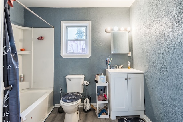 full bathroom with hardwood / wood-style flooring, vanity, toilet, and shower / tub combo