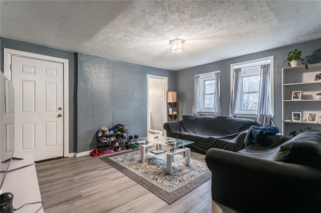 living room featuring a textured ceiling and hardwood / wood-style flooring