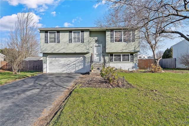 raised ranch with a garage and a front yard