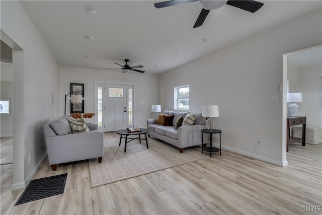 living room featuring light hardwood / wood-style flooring and ceiling fan