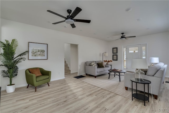 living room featuring ceiling fan and light hardwood / wood-style flooring