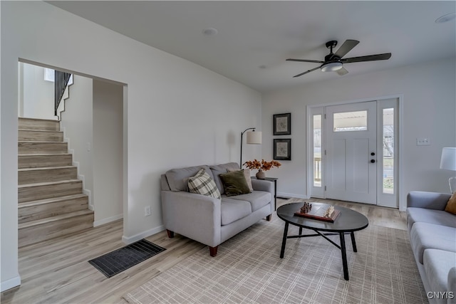 living room with ceiling fan and light hardwood / wood-style flooring