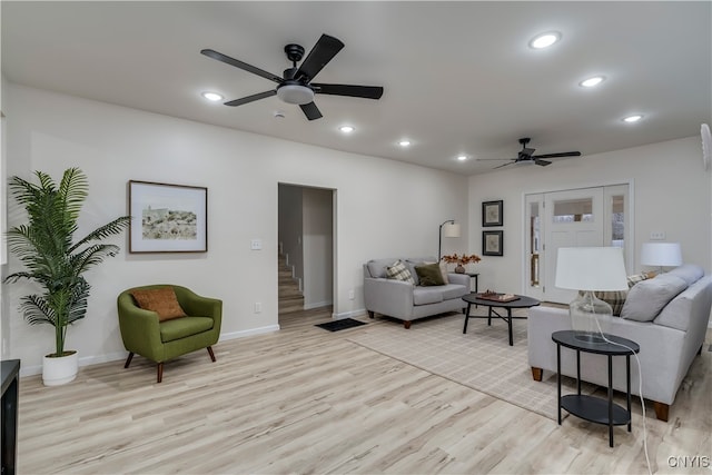 living room with light wood-type flooring and ceiling fan