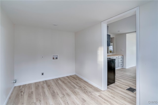 laundry room featuring electric dryer hookup, light hardwood / wood-style floors, and hookup for a washing machine