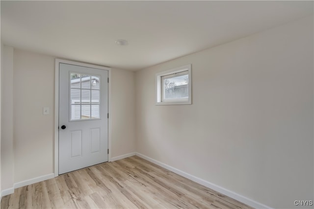 doorway with a healthy amount of sunlight and light hardwood / wood-style floors