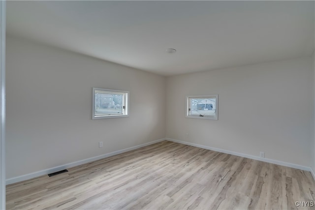 unfurnished room with light hardwood / wood-style floors