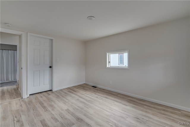 spare room with light wood-type flooring