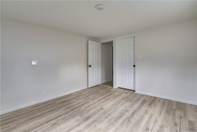 unfurnished room with light hardwood / wood-style floors