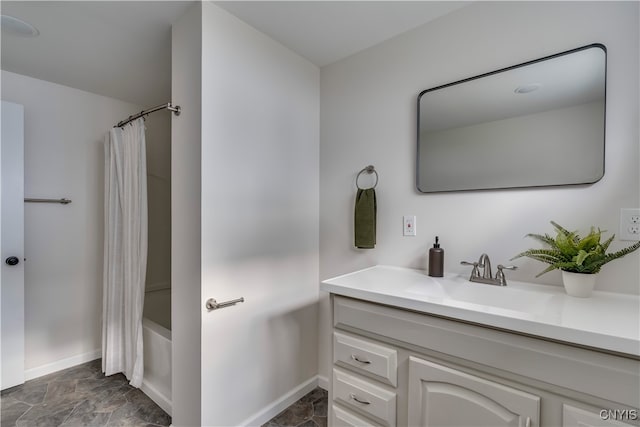 bathroom featuring vanity and shower / bathtub combination with curtain