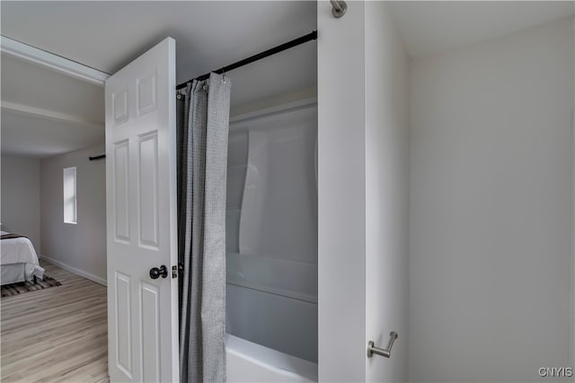 bathroom featuring shower / bath combo with shower curtain and hardwood / wood-style flooring