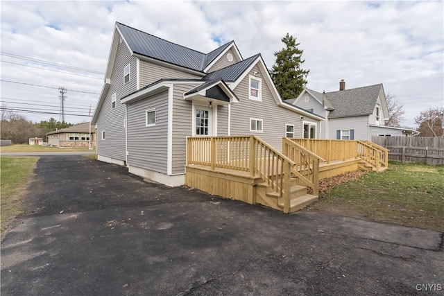 back of house featuring a deck