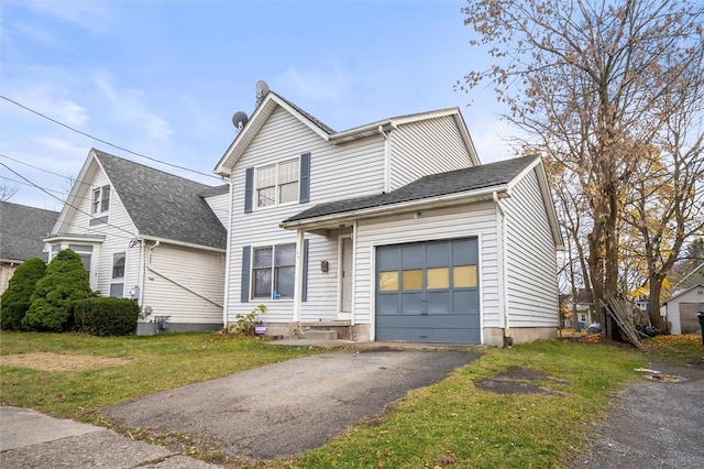 view of property with a garage and a front lawn