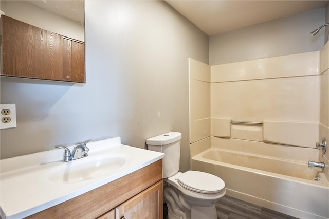 full bathroom featuring hardwood / wood-style floors, vanity, toilet, and shower / washtub combination