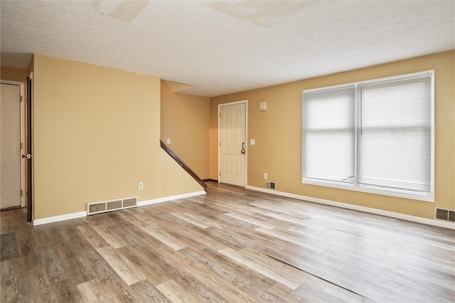 interior space featuring wood-type flooring and a textured ceiling