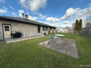 rear view of house with a patio area and a lawn