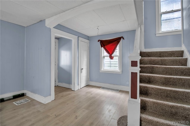 stairs featuring hardwood / wood-style flooring