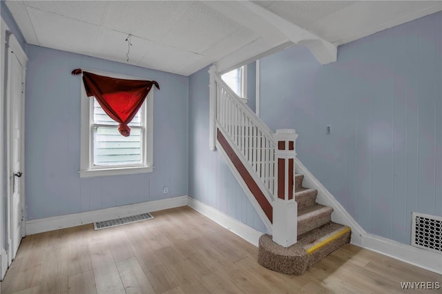 stairs featuring wood-type flooring