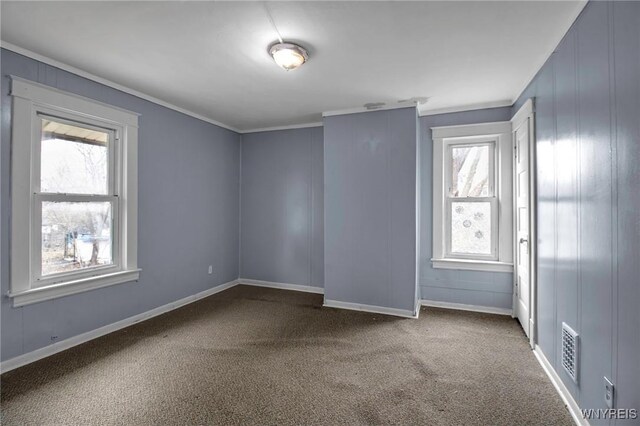 1857 Ontario Ave, Niagara Falls, NY 14305 - empty room featuring dark carpet, ornamental molding, and a decorative wall