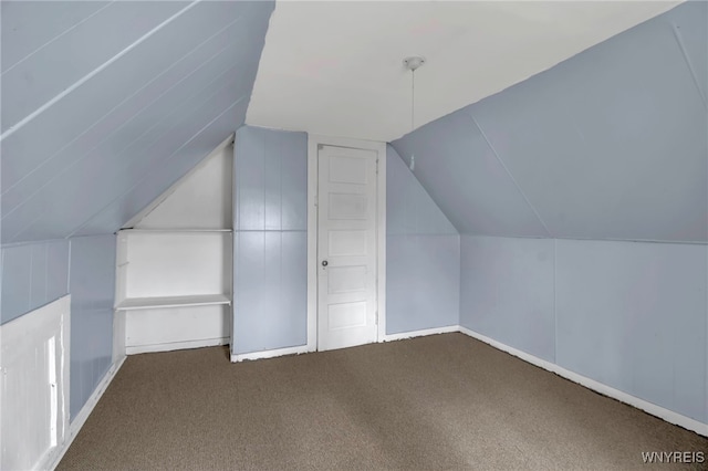 bonus room featuring carpet flooring and vaulted ceiling