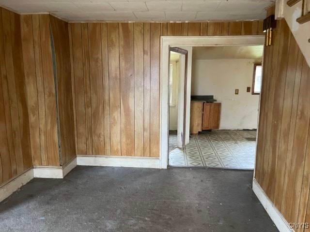 spare room with wood walls