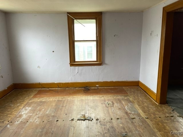 unfurnished room with hardwood / wood-style floors