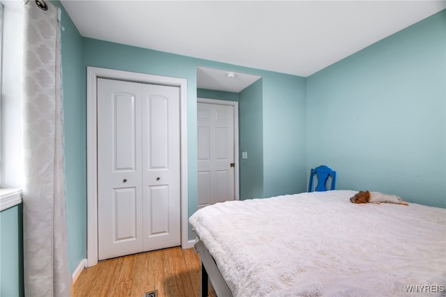 bedroom featuring a closet and light hardwood / wood-style flooring