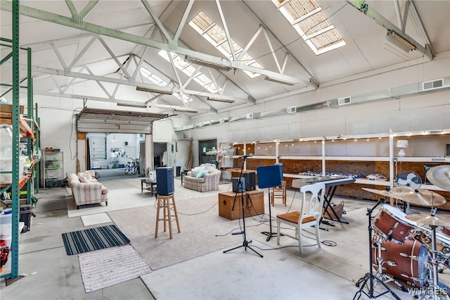 misc room featuring concrete flooring and high vaulted ceiling