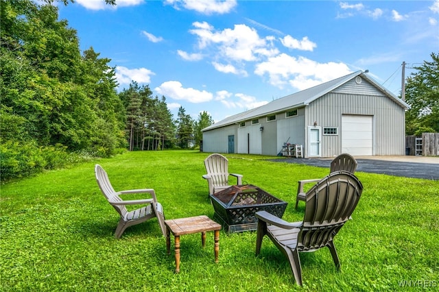 view of yard featuring an outbuilding and a fire pit